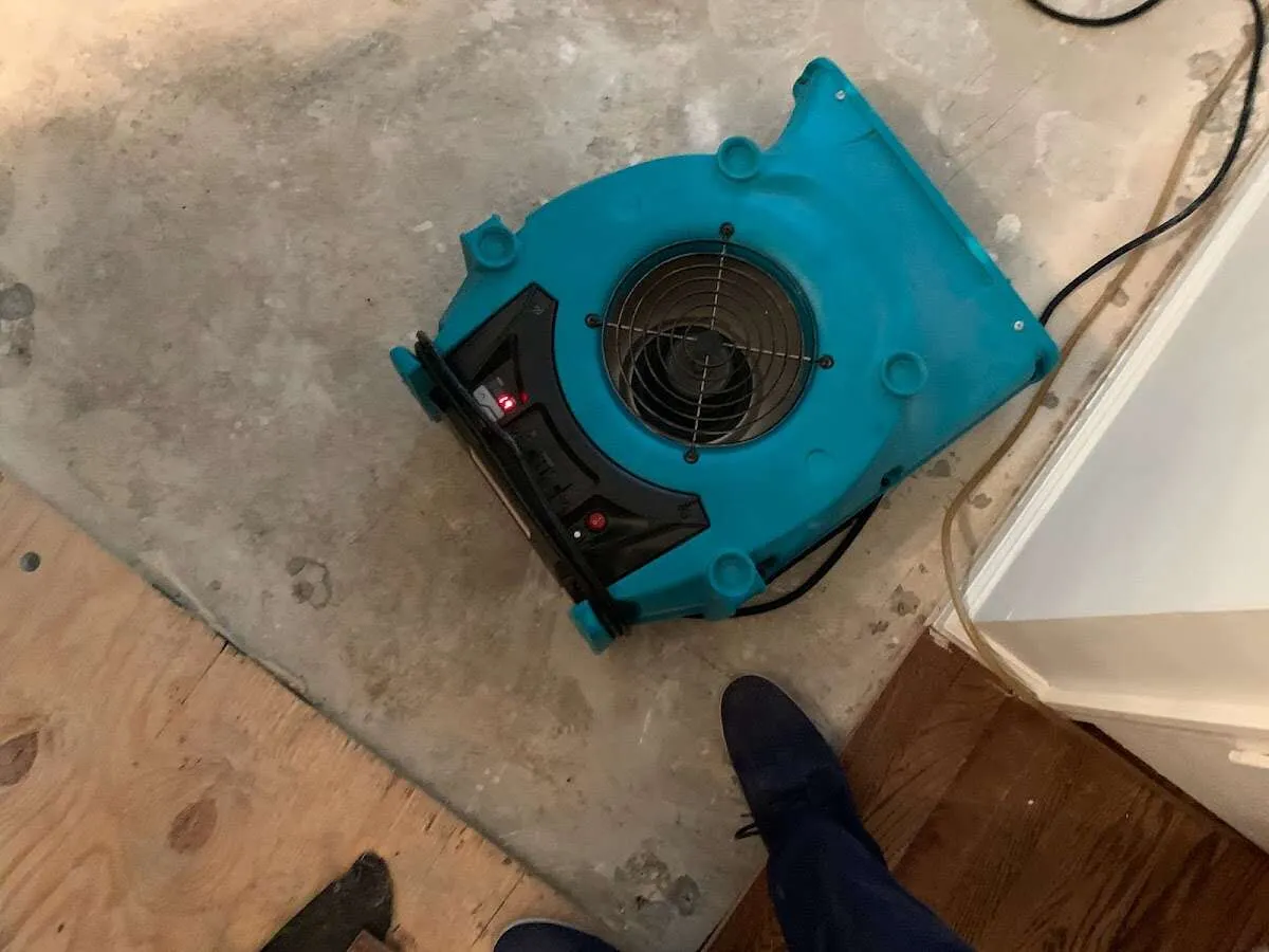Air mover drying subfloor during Commercial Water Damage Restoration in Oak Forest